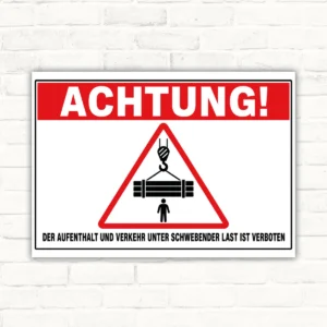 Verbotsschild mit Warntext „Der Aufenthalt und Verkehr unter schwebender Last ist verboten“ und Symbol für hängende Last.