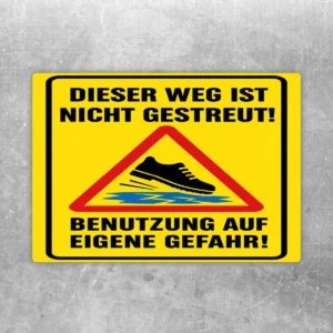 Warnaufkleber mit Text „Dieser Weg ist nicht gestreut“ und rotem Warn-Dreieck auf gelbem Hintergrund.