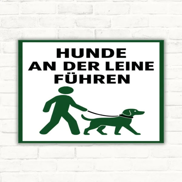 Hunde an der Leine führen Schild mit gut lesbarem Motiv und klarer Beschriftung als bedrucktes Schild aus Aluminium-Verbundplatte.