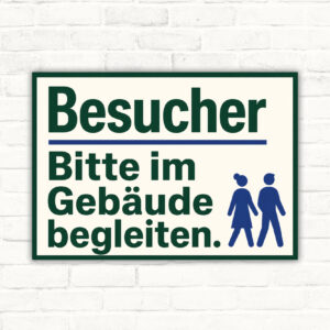 Besucher Schild mit Wortlaut „Besucher Bitte im Gebäude begleiten.“ und Illustration von Personen im Empfangsbereich.