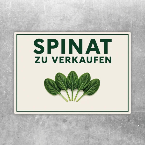 Querformat-Aufkleber mit der Aufschrift „Spinat zu verkaufen“ und fünf grünen Spinatblättern auf hellem Hintergrund.